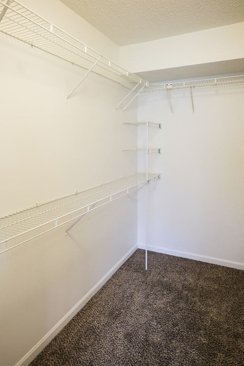 Large walk in closet with storage in master bedroom in Regency apartments Bettendorf, Iowa